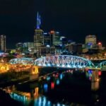 a bridge over a river with lights at night