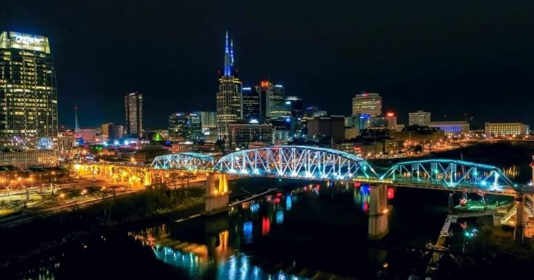 a bridge over a river with lights at night