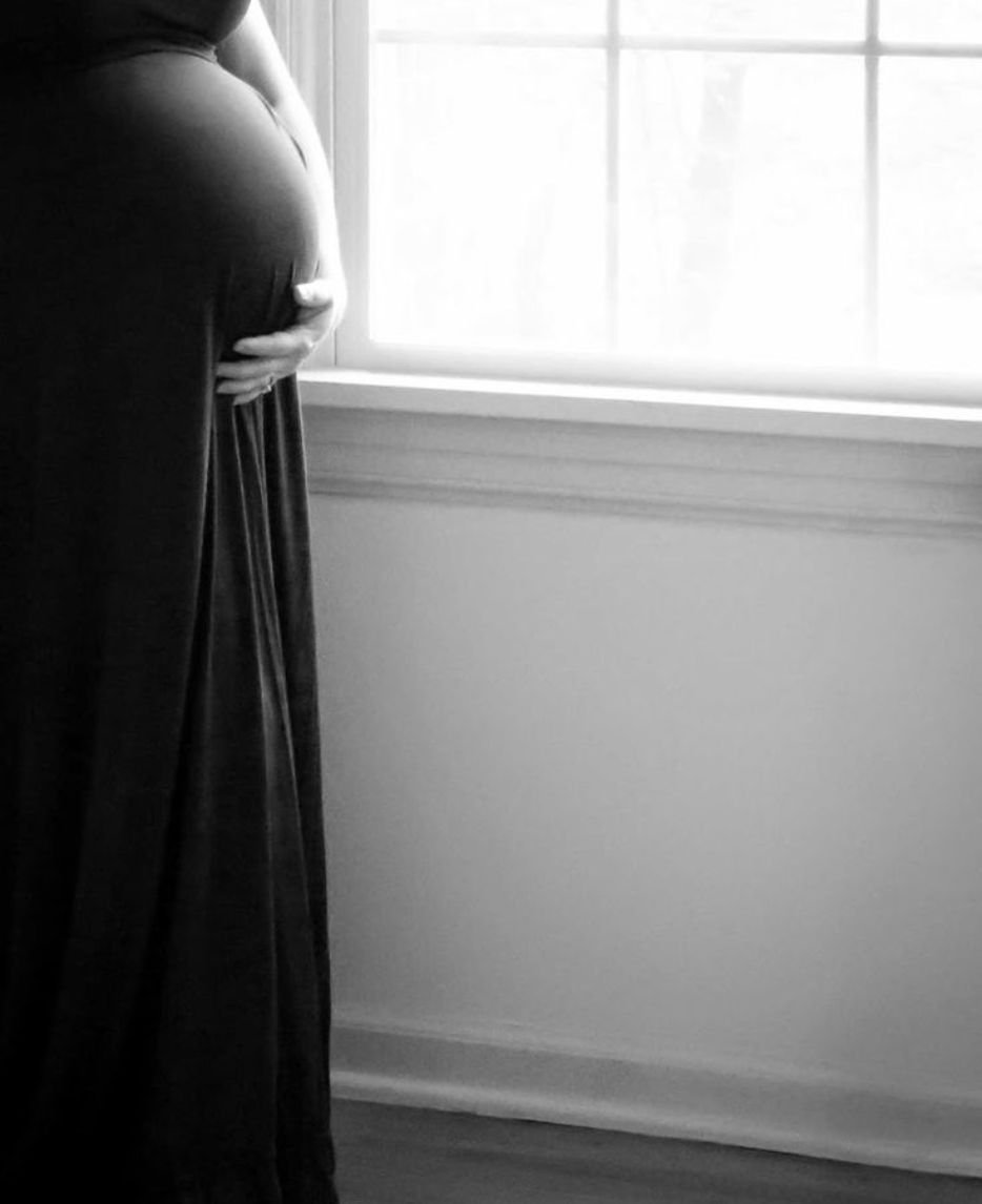 At-home maternity photos capturing intimate, natural moments of expecting mothers in cozy, familiar settings.