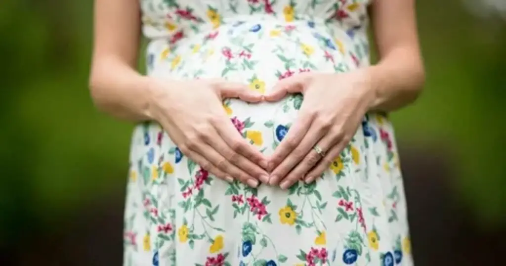 A couple poses creatively for a maternity photoshoot, showcasing unique and artistic ideas for capturing their pregnancy journey.