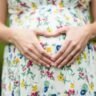 A couple poses creatively for a maternity photoshoot, showcasing unique and artistic ideas for capturing their pregnancy journey.