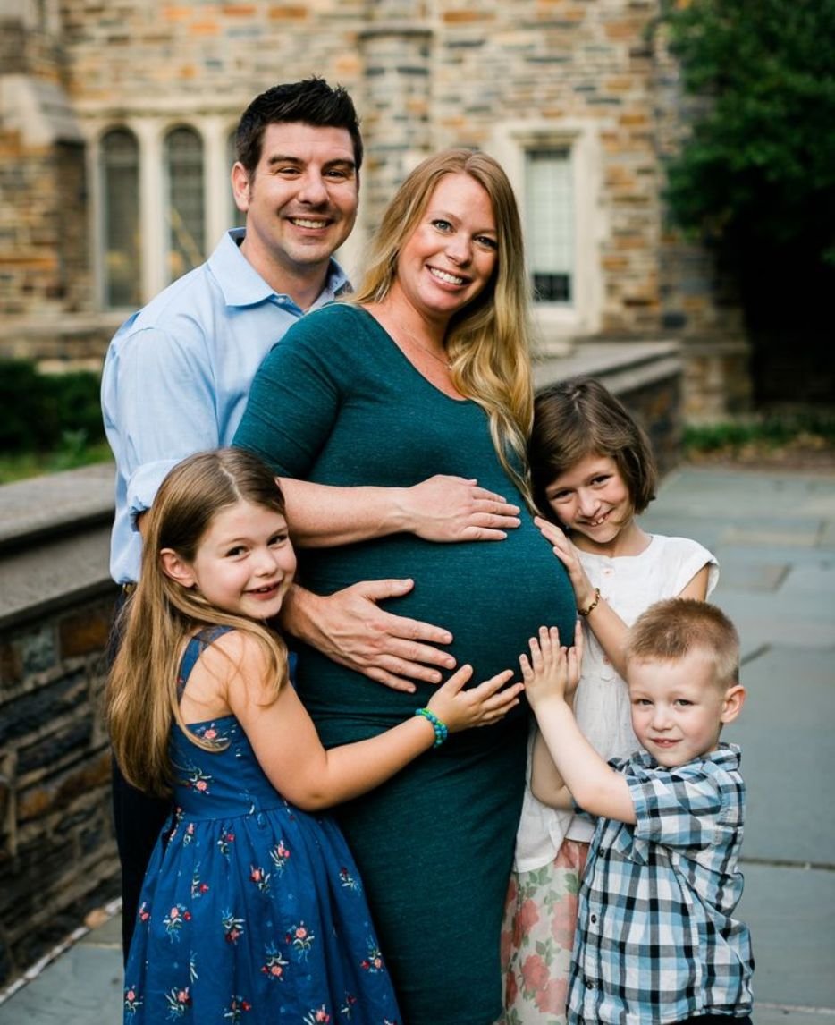 Heartwarming maternity photo with siblings embracing their expectant mother, capturing the joy of a growing family.