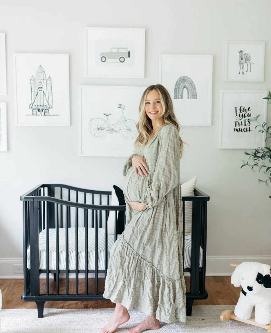 Cozy maternity photoshoot in a beautifully decorated nursery, capturing a mother's joy and anticipation.