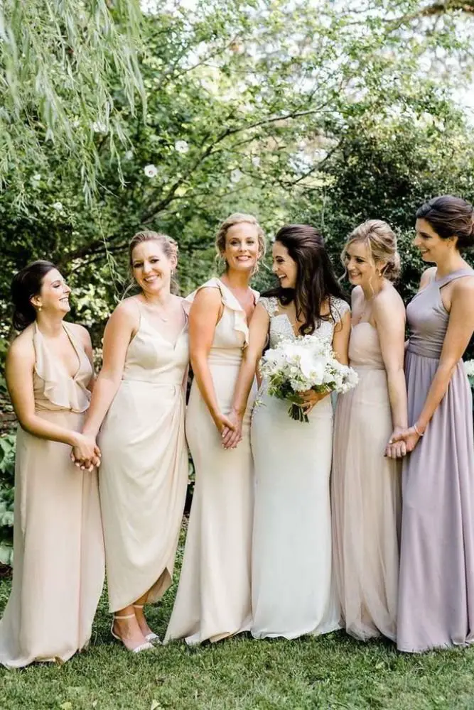 A joyful bride with her bridesmaids, all dressed for a stunning wedding party celebration