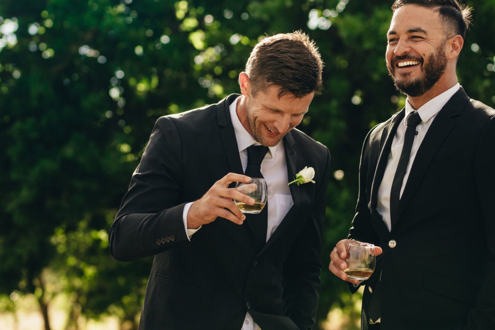 Groom and Best Man sharing a moment during the wedding party celebration.