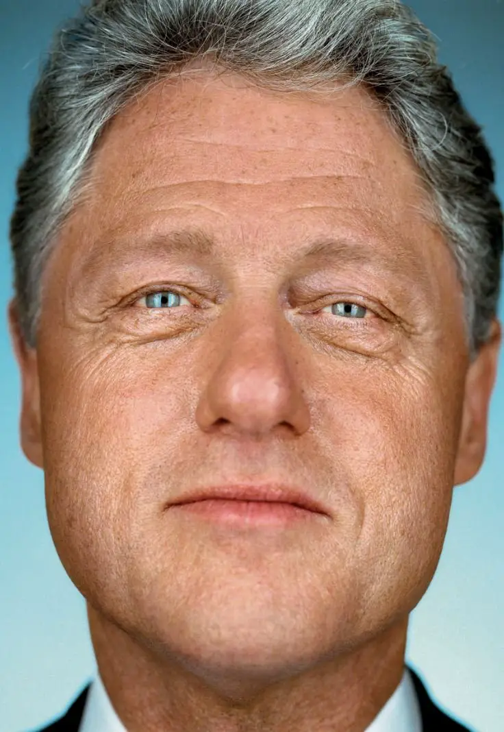 Close-up portrait of a man with gray hair, blue eyes, and a calm expression, photographed with detailed focus on his facial features.