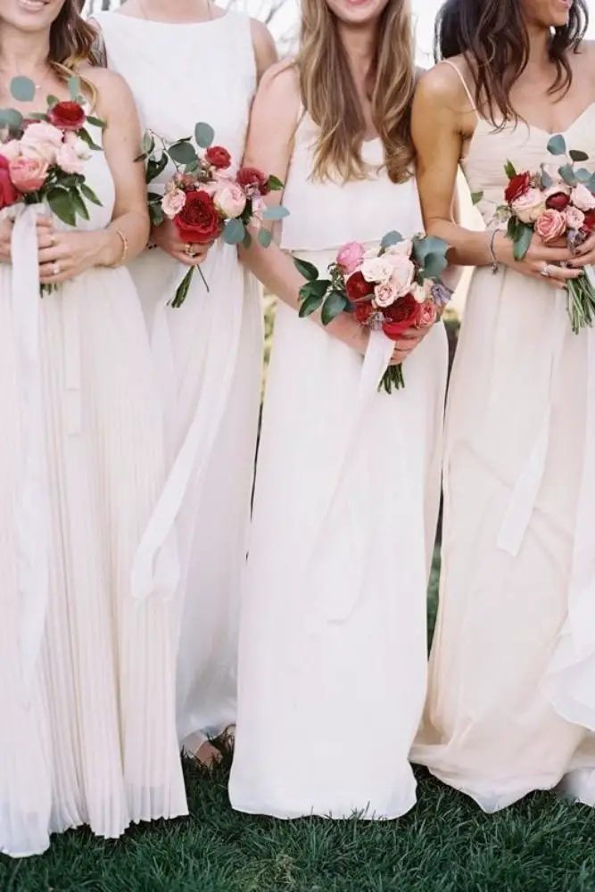 Bridesmaids' bouquets for a wedding party, featuring elegant flowers and greenery.