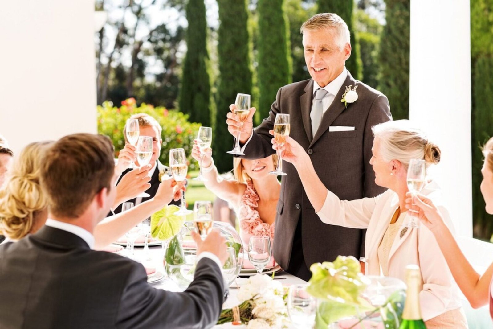 Wedding party toasting with champagne glasses at a joyful celebration.