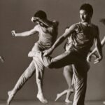 Dancers in black and white suspended in the air, illustrating fluidity and artistry in contemporary photography.