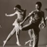 Dancers in black and white suspended in the air, illustrating fluidity and artistry in contemporary photography.