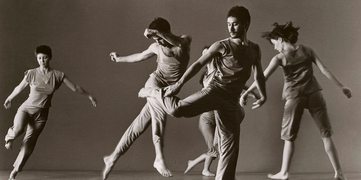 Dancers in black and white suspended in the air, illustrating fluidity and artistry in contemporary photography.