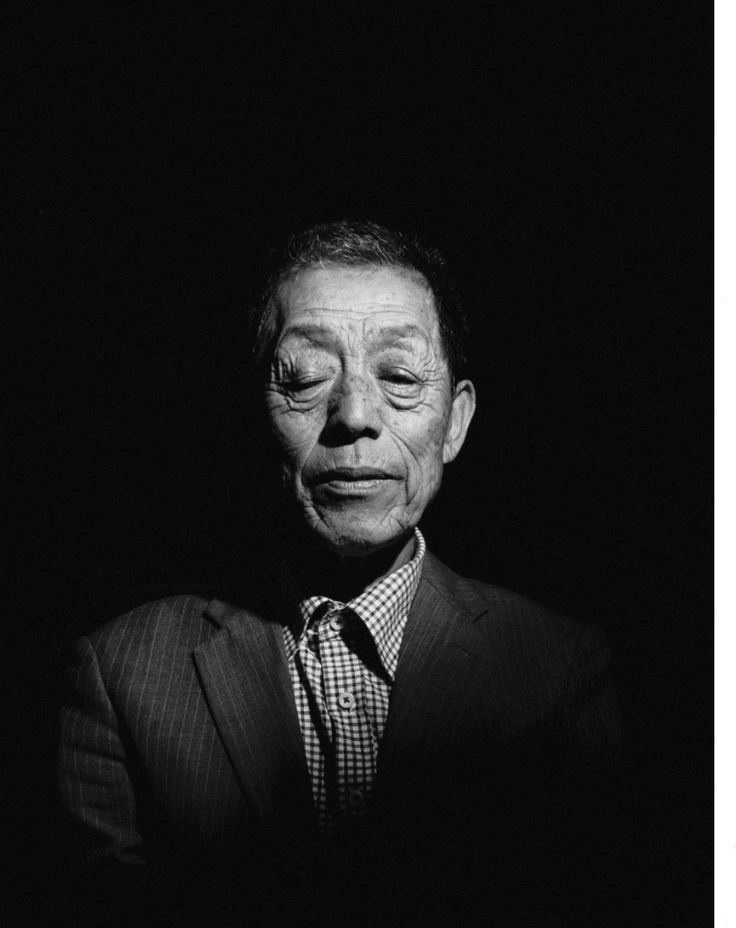 An Asian man dressed in a sharp suit and tie, exuding confidence and professionalism.