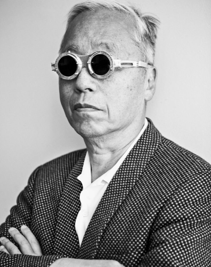 An Asian man in sunglasses and a stylish jacket, exuding cool vibes and confidence.